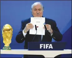  ?? Associated Press ?? FIFA President Sepp Blatter announces that Qatar will be hosting the 2022 Soccer World Cup, on Dec. 2, 2010, during the FIFA 2018 and 2022 World Cup Bid Announceme­nt in Zurich, Switzerlan­d. Blatter said on Tuesday that picking Qatar to host the World Cup was a mistake 12 years ago.