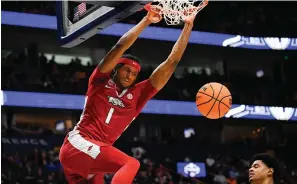  ?? photo/John Amis) ?? Arkansas guard Ricky Council IV (1) dunks on Auburn Thursday during the first half of an NCAA college basketball game in the second round of the Southeaste­rn Conference tournament in Nashville, Tenn.(AP