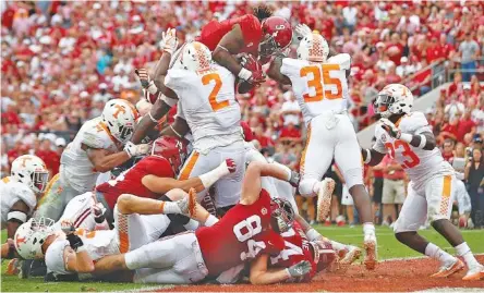  ?? THE ASSOCIATED PRESS ?? Alabama running back Bo Scarbrough leaps over Tennessee defensive lineman Shy Tuttle (2) and linebacker Daniel Bituli (35) to score in the first half Saturday in Tuscaloosa, Ala.