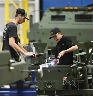  ?? (Arkansas Democrat-Gazette/Staci Vandagriff) ?? Assembly-line operators work on the HIMARS production line at the Lockheed Martin Missiles and Fire Control facility in Camden on Thursday.