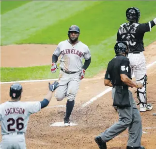  ?? KAMIL KRZACZYNSK­I/THE ASSOCIATED PRESS ?? Cleveland Indians outfielder Abraham Almonte scores on a single hit by shortstop Francisco Lindor in the seventh inning against the White Sox on Monday in Chicago.