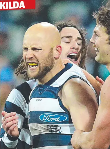  ??  ?? MAN OF THE MOMENT: Gary Ablett’s teammates get around him after one his last-quarter goals swings the game. It means coach Chris Scott and captain Joel Selwood, below, can smile after the game.