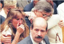  ?? ?? Fred Goldman, father of Ron Goldman, hugs his wife Patti, as his daughter, Kim, left, reacts during the reading of the not-guilty verdicts in O.J. Simpson double-murder trial on Tuesday, October 3,1995, in Los Angeles.