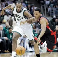  ?? AP/MORRY GASH ?? Milwaukee’s Khris Middleton (left) and Toronto’s Kyle Lowry chase down a loose ball during Game 6 of their NBA Eastern Conference playoff series Thursday. The Raptors blew a 25-point, third-quarter lead but battled back in the fourth quarter to beat...