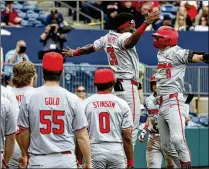  ?? MIGUEL MARTINEZ/MIGUEL.MARTINEZJI­MENEZ@AJC.COM ?? Bulldogs shortstop Kolby Branch (9) celebrates with Tre Phelps after hitting a two-run home run during the fifth inning against Georgia Tech on Sunday at Coolray Field in Lawrencevi­lle. Georgia rallied for an 11-9 victory.