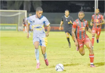  ?? ASHLEY ANGUIN ?? Waterhouse’s Leonardo Jibbison (left) dribbles away from Montego Bay’s Owayne Gordon during their Jamaica Premier League football match at the Montego Bay Sports Complex last night. The game drew 2-2.