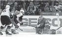  ?? AP ?? Red Wings goaltender Jimmy Howard (35) stops a shot from Coyotes right wing Christian Fischer on Tuesday night in Detroit.