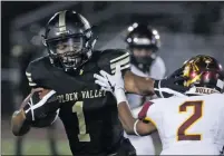  ??  ?? Katharine Lotze/The Signal Golden Valley’s DeGabriel Floyd (1) pushes off Highland’s Demani Jamison (2) during the Grizzlies’ first football game of the season at Canyon High School on Friday.