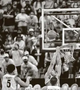  ?? Justin Rex / Associated Press ?? Texas couldn’t get many shots to fall in Saturday’s loss at Lubbock, with even this unconteste­d dunk attempt by forward Jericho Sims rimming out.