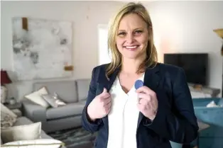  ?? STAFF PHOTO BY C. B. SCHMELTER ?? Ashley Harrison poses with her 6-month chip at The Launch Pad on Monday. The Launch Pad is a sober living home for women founded by local restaurate­ur Scottie Bowman.