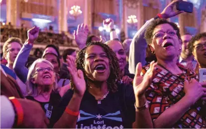  ?? ASHLEE REZIN/SUN-TIMES ?? Supporters at mayoral candidate Lori Lightfoot’s election night rally Tuesday at the Hilton Chicago cheer as poll numbers trickle in showing Lightfoot in the lead against Toni Preckwinkl­e.