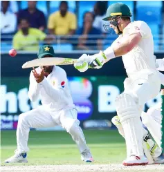  ?? AFP photo ?? Paine (right) plays a shot during day five of the first Test cricket match in the series against Pakistan at the Dubai Internatio­nal Stadium in Dubai in this Oct 11.—