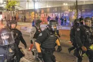  ?? Nathan Howard / Getty Images ?? Police have assaulted journalist­s at protests like this one in Portland, Ore., in September.