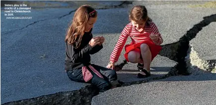  ?? IAIN MCGREGOR/STUFF ?? Sisters play in the cracks of a damaged road in Christchur­ch in 2011.