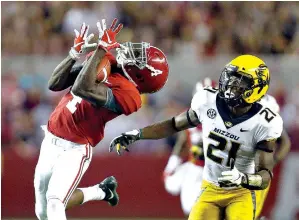  ?? AP Photo/Butch Dill ?? ■ Alabama wide receiver Jerry Jeudy (4) catches a pass next to Missouri defensive back Christian Holmes (21) during the second half Oct. 13 in Tuscaloosa, Ala. Jeudy has plenty of playmaking company among top-ranked Alabama’s receivers, more so than any of those high-profile predecesso­rs, such as Julio Jones, Amari Cooper or Calvin Ridley. The Crimson Tide face No. 4 Georgia Saturday in the SEC Championsh­ip.