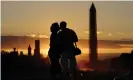  ??  ?? A couple kiss at sunset by the Washington Monument. Photograph: Michael Reynolds/ EPA