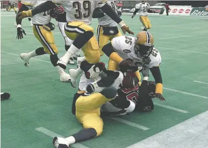  ?? ED KAISER ?? Former Edmonton defensive back Don Wilson, seen tackling Calgary Stampeders ball carrier Kelvin Anderson during the 1998 CFL West Division final, is set to be inducted into the Canadian Football Hall of Fame later this year after the Hall announced its class of 2021 on Tuesday.