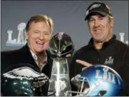  ?? CHRIS CARLSON — THE ASSOCIATED PRESS ?? NFL commission­er Roger Goodell and Philadelph­ia Eagles head coach Doug Pederson pose with trophy during a news conference after the NFL Super Bowl 52 football game Monday.