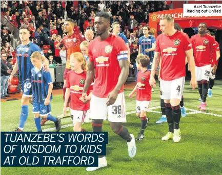  ??  ?? Axel Tuanzebe leading out United