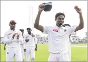  ??  ?? Bangladesh’s Taijul Islam (R) acknowledg­es the crowd as he gets 11 wickets during Day 3 of the first Test against Zimbabwe