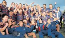  ?? PHOTO / GETTY IMAGES ?? Rotorua Boy’s High School celebrates with the Barbarians Cup following their win in the National First XV Championsh­ip Final in 2015.