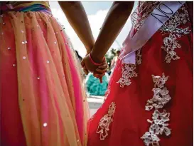  ??  ?? Sisters Julia, 14, and Isabel Pierce, 11, hold hands Wednesday as they take part in a dance protest at the Capitol against the sanctuary cities ban. The girls also passed out flyers explaining the law’s effect on Latino communitie­s.