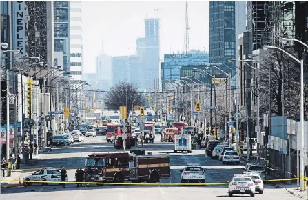  ?? NATHAN DENETTE THE CANADIAN PRESS ?? Yonge Street in Toronto was closed down last Monday after a van mounted a sidewalk and struck numerous pedestrian­s, killing 10 and injuring 16.