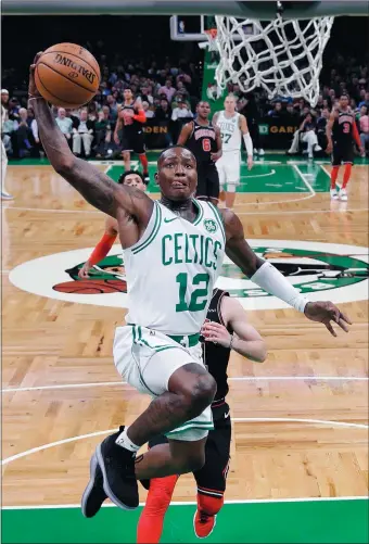  ?? CHARLES KRUPA/AP PHOTO ?? Boston Celtics guard Terry Rozier (12) lines up a dunk during the second half of Wednesday’s 111-82 victory over the Chicago Bulls at TD Garden in Boston.