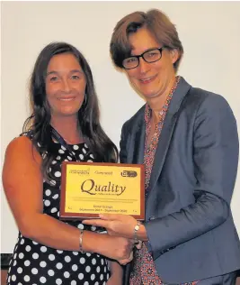  ??  ?? Lyndsey Floyd, left, manager at Cedars Care Group recieves the award from Vic Rayner of the National Care Forum