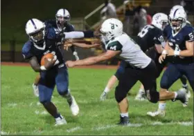  ?? AUSTIN HERTZOG - DIGITAL FIRST MEDIA ?? Pottstown quarterbac­k Josiah Wiggins, left, stiff-arms Methacton’s Michael Ciriello (8) on a carry Friday.