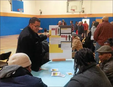  ?? RECORD FILE PHOTO ?? In this file photo from a Martin Luther King Jr. Day event last year, Block Center mentor Steven Figueroa is seen explaining to a group of community members about what to do if they are ever stopped by the police.