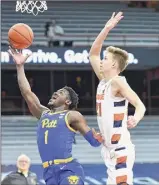  ?? Dennis Net / Associated Press ?? Pittsburgh guard Xavier Johnson, left, became the 47th player in program history to reach 1,000 career points.