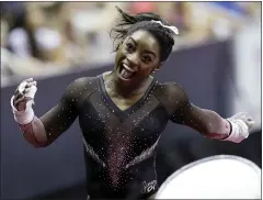  ?? CHARLIE RIEDEL — THE ASSOCIATED PRESS ?? Olympic champion Simone Biles celebrates after competing in the uneven bars to win the all-around title at the U.S. Gymnastics Championsh­ips on Sunday.