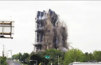  ?? Jacqueline Larma / Associated Press ?? Martin Tower, the former world headquarte­rs of Bethlehem Steel, implodes in Bethlehem, Pa. Plans call for a $200 million developmen­t with offices, retail stores, a hotel and apartments.