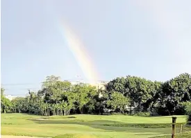  ?? —MUSONG R. CASTILLO ?? A rainbow plunges into the trees that serve as a backdrop for Manila Southwoods’ sixth fairway.