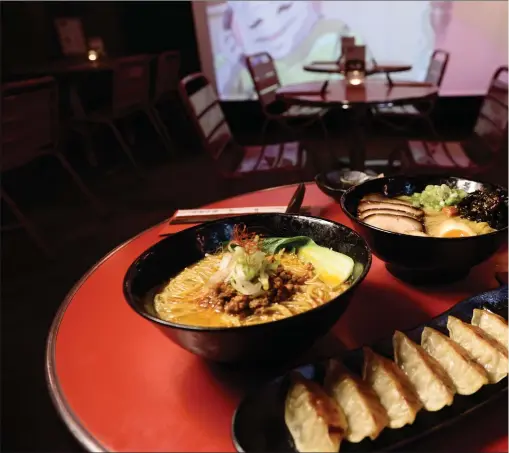  ?? PHOTOGRAPH: JAMIE SIMPSON ?? Diners at Ramen Dayo can watch Japanese animations play out on a screen while slurping their way through tonkotsu or chowing down on gyoza