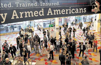  ??  ?? People attend the annual Shooting, Hunting and Outdoor Trade Show on Wednesday in Las Vegas. Arkansas Gov. Asa Hutchinson attended this year’s event.