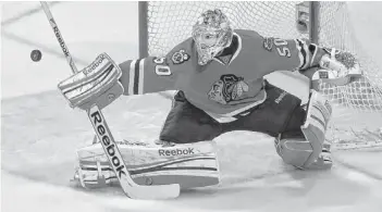  ?? CHARLES REX ARBOGAST/AP ?? Blackhawks goalie Corey Crawford deflects a shot by the Kings during the third period in Game 1 of the Western Conference finals in Chicago on Saturday. Crawford made 21 saves.