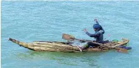  ??  ?? A fisherman on Lake Tana uses a modern nylon net although his papyrus boat is a design that would have been used on the Nile for millennia. Below: African angels decorate the ceiling and rafters of Debre Berhan Selassie.