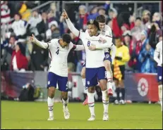  ?? Associated Press ?? The United States’ Weston McKennie celebrates his goal with Tyler Adams (left) and Christian Pulisic during the second half of a FIFA World Cup qualifying soccer match against Mexico on Friday.