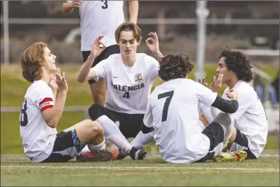  ?? Chris Torres/ The Signal ?? Valencia captain Daniel Corcione (28) celebrates with his teammates after scoring a penalty kick in the first half of a Foothill League match at West Ranch High School on Thursday. Valencia won 3-1.