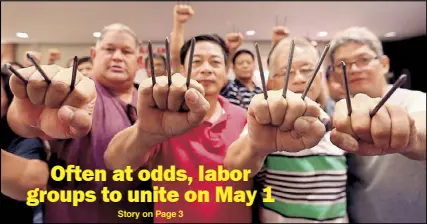  ?? EDD GUMBAN ?? Members of the labor coalition Nagkakaisa hold up fists with constructi­on nails to symbolize the government’s ‘pangakong napako’ or unfulfille­d promise of issuing an order ending contractua­lization.