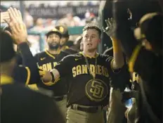  ?? Associated Press ?? Jake Cronenwort­h celebrates his fifth-inning home run. An infield single in the sixth gave him the cycle.