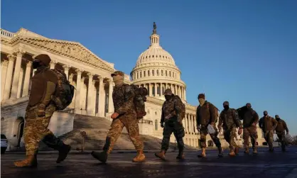  ?? Photograph: Joshua Roberts/Reuters ?? Members of the National Guard file past the US Capitol building in Washington DC.