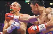  ?? John Locher Associated Press ?? MANNY PACQUIAO lands a punch against the bigger and younger Keith Thurman in the fifth round.