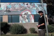  ??  ?? Carlos Velazquez shows off a mural at the Gardner Health Center in San Jose last month.