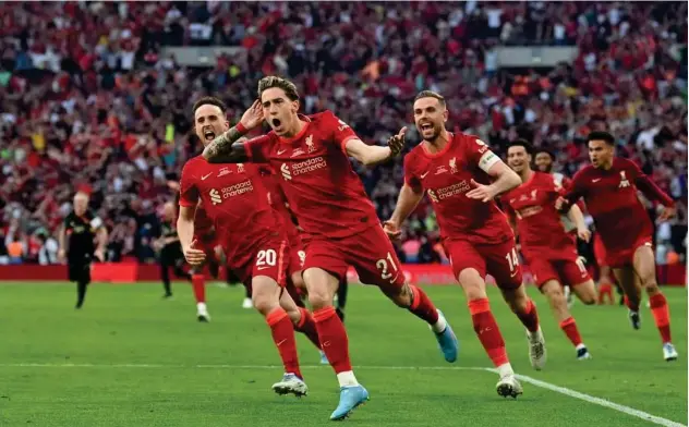  ?? Agence France-presse ?? ↑
Liverpool’s Kostas Tsimikas (second right) celebrates with team-mates after scoring a goal against Chelsea during the penalty shootout in the English FA Cup final on Saturday.