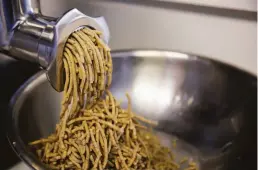  ?? Samantha Laurey / The Chronicle ?? Eleana Hsu uses a meat grinder, above, to process koji rice, beans and mushrooms for miso. Left: Shared Cultures’ shiitake katsuobush­i miso.