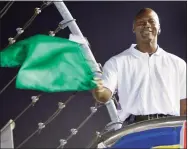  ?? Chuck Burton / Associated Press ?? Charlotte Bobcats owner Michael Jordan practices waving the green flag before a NASCAR All-Star race at Charlotte Motor Speedway in 2010.