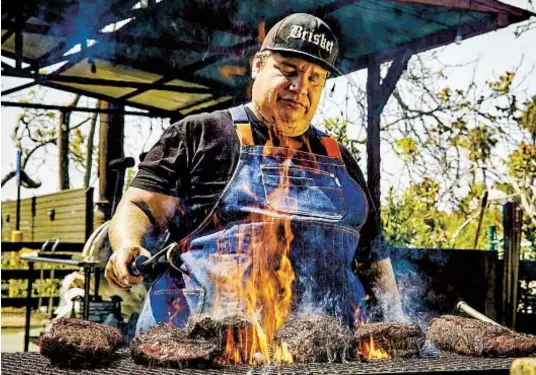 ?? KATRINA FREDERICK HERITAGE BARBECUE & BREWERY ?? Pitmaster and co-owner Daniel Castillo mans the grill at Heritage Barbecue & Brewery in San Juan Capistrano.